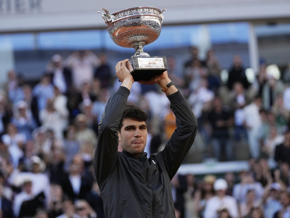 Winner Spain's Carlos Alcaraz celebrates with the trophy as he won the men's final match of the French Open tennis tournament against Germany's Alexander Zverev at the Roland Garros stadium in Paris on Sunday.