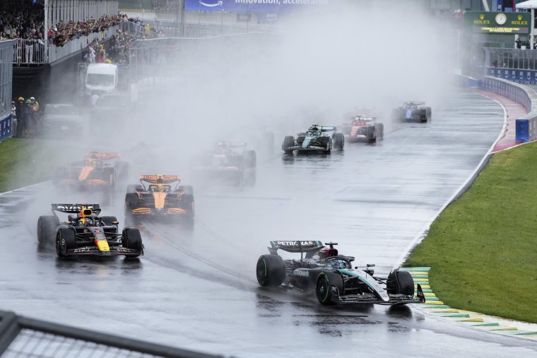 Mercedes driver George Russell of the United Kingdom leads with Red Bull driver Max Verstappen behind him at the Canadian Grand Prix