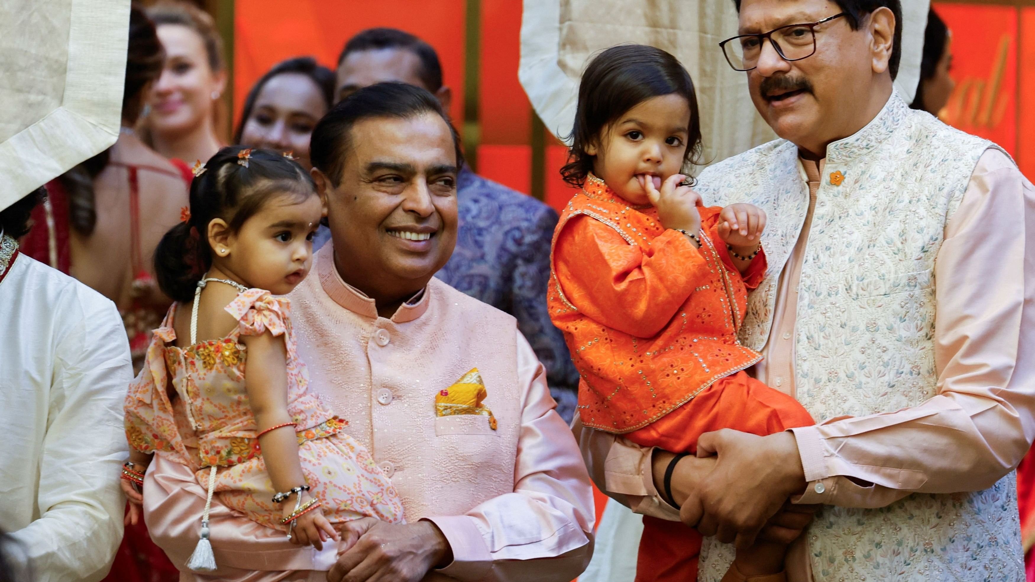 Mukesh Ambani and Ajay Piramal pose for a picture with their grandchildren during the pre-wedding ceremony of Anant Ambani and Radhika Merchant, at Ambani's residence in Mumbai.