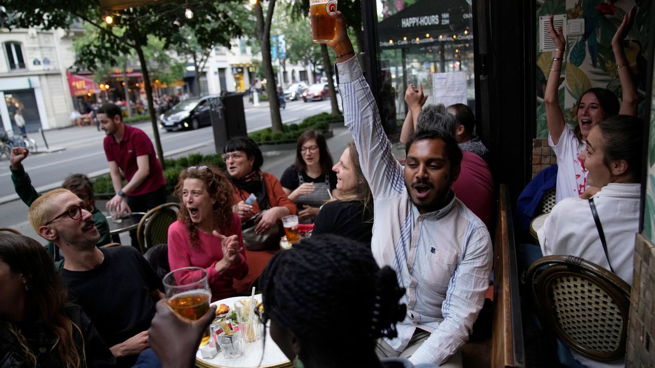 People react to the projection of results in Paris. 