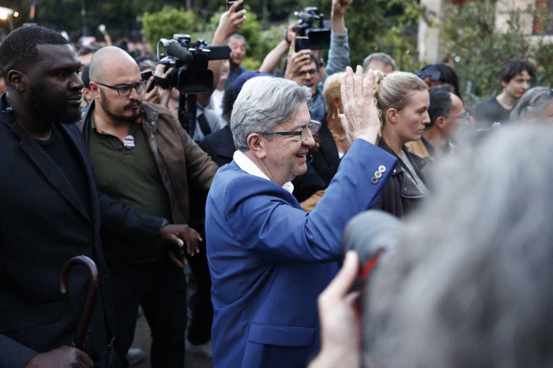 Founder of left-wing party La France Insoumise (LFI) Jean-Luc Melenchon waves at supporters on the election night in Paris on Sunday.