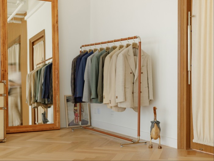 A rack of jackets beside a large mirror in The Anthology’s showroom