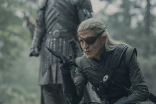 Ewan Mitchell as Aemond Targaryen, holding a dagger while kneeling, in 'House of the Dragon'