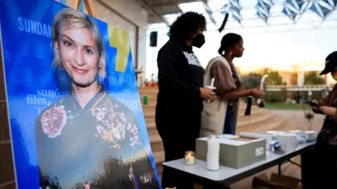 Reuters An image of cinematographer Halyna Hutchins displayed at a vigil after her death 