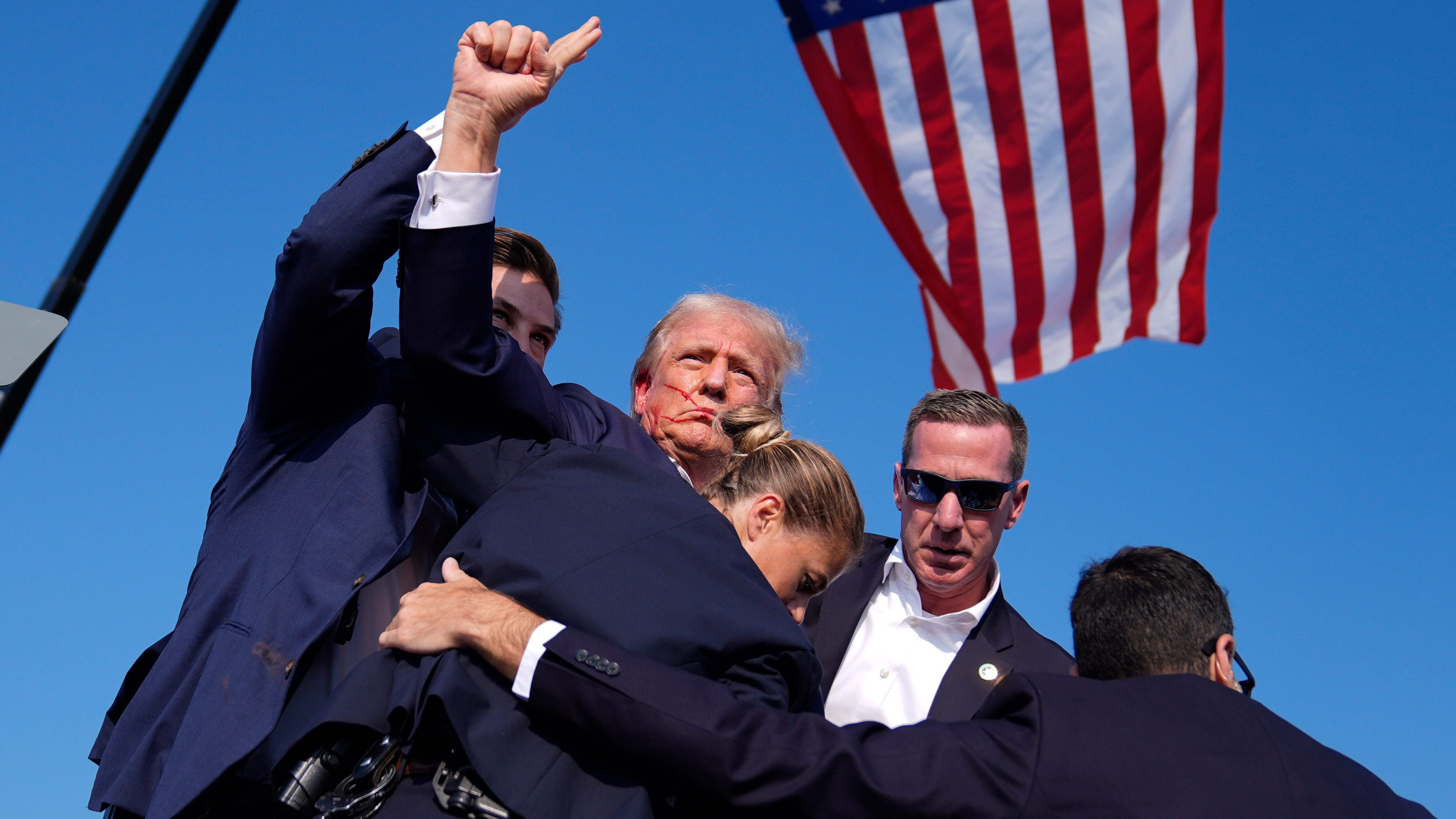 Republican presidential candidate former President Donald Trump is surrounded by U.S. Secret Service agents at a campaign rally, Saturday, July 13, 2024, in Butler, Pa.