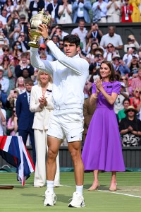 Kate Middleton wearing Safiyaa purple dress at Wimbledon 2024, 
 LONDON, ENGLAND - JULY 14: Carlos Alcaraz poses with the winner's trophy after beating Serbia's Novak Djokovic during their men's singles final tennis match on day fourteen of the Wimbledon Tennis Championships at the All England Lawn Tennis and Croquet Club on July 14, 2024 in London, England. (Photo by Karwai Tang/WireImage)