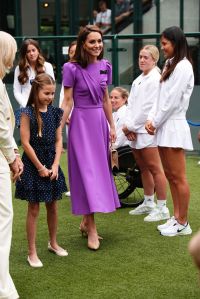 Kate Middleton wearing Safiyaa purple dress at Wimbledon 2024, 
 LONDON, ENGLAND - JULY 14: Catherine, Princess of Wales (C) and Princess Charlotte (L) after meeting Emma Raducanu (R) during a visit to the All England Lawn Tennis and Croquet Club in Wimbledon, south west London, on day fourteen of the Wimbledon Tennis Championships on July 14, 2024 in London, England. The Princess of Wales will present the trophy to the winner of the men's final. (Photo by Aaron Chown - WPA Pool/Getty Images)