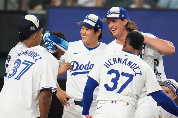 Dodgers star Shohei Ohtani, center, and teammates Tyler Glasnow (31)...