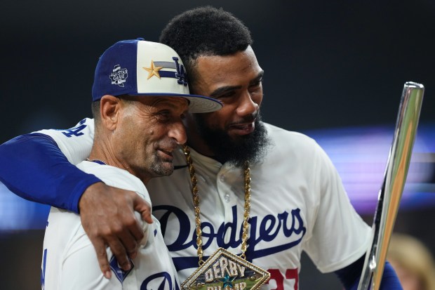 Dodgers outfielder Teoscar Hernández, right, celebrates with Dodgers third base...