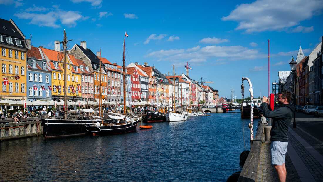 Tourists visit the Nyhavn, a 17th-century waterfront, in Copenhagen, Denmark, in this 2021 file photo.