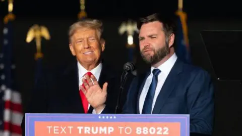 Getty Images Trump and Vance side by side behind a podium