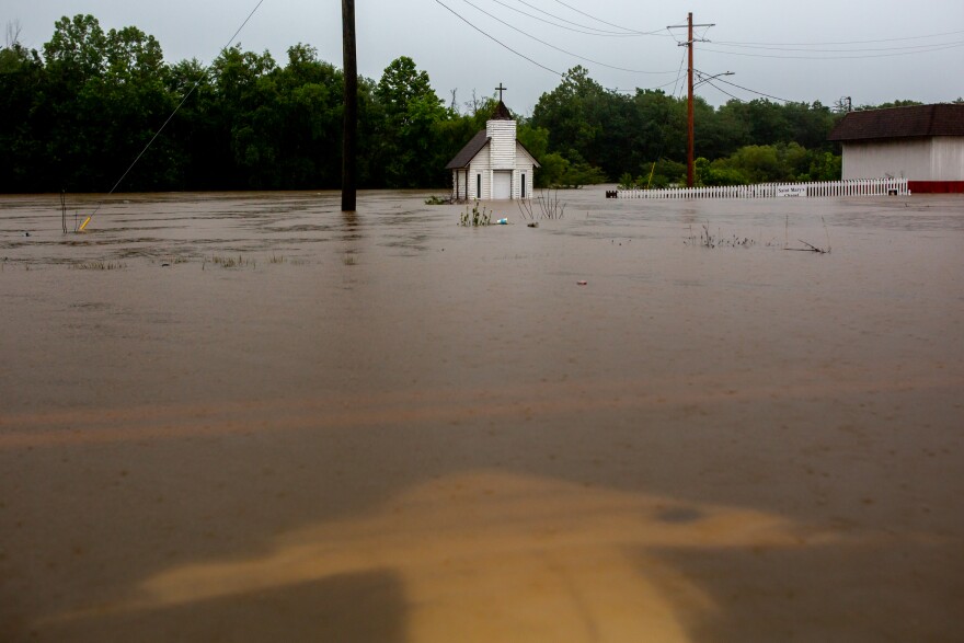 Floodwaters pour onto Illinois Route 127 on Tuesday, July 16, 2024, just oustside Nashville, Illinois.