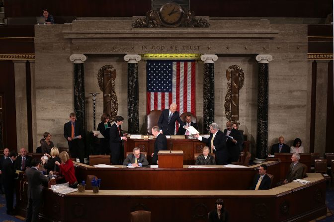 Biden hands a vote certificate to US Rep. Robert Brady as Congress officially counts the Electoral College votes in January 2013. Obama and Biden were elected to a second term in November 2012.