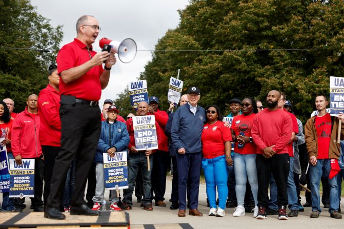 Shawn Fain, president of the United Auto Workers, speaks as Biden, center, joins <a href=