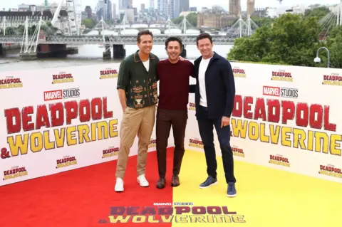 Disney Ryan Reynolds (R) with director Shawn Levy (centre) and Hugh Jackman (L)