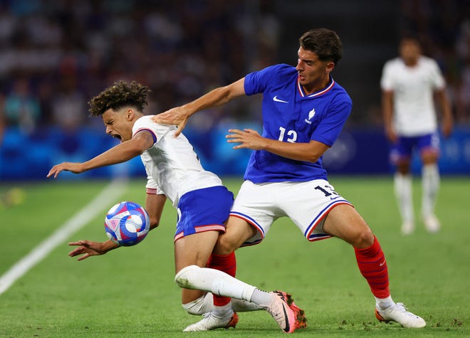 France's Joris Chotard battles with the United States' Kevin Paredes.