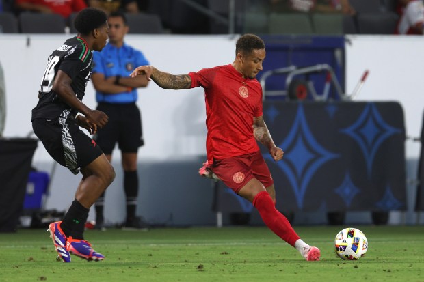 AFC Bournemouth midfielder Marcus Tavernier, right, kicks the ball during...