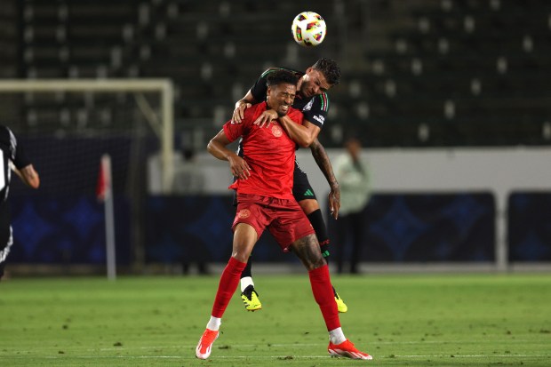 AFC Bournemouth forward Daniel Jebbison, front, vies for the ball...