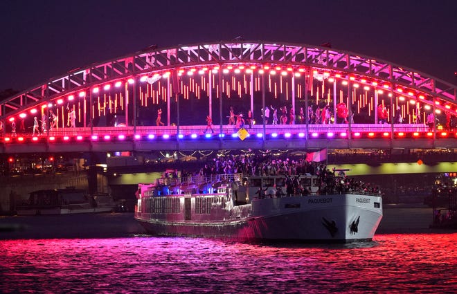 The delegation from France makes its way up the Seine during Friday's opening ceremony.