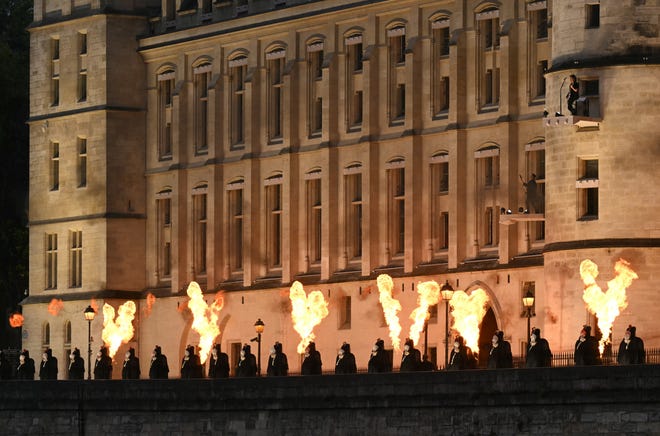 Headless figures depicting the 18th century Queen Marie Antoinette line up with fire shows along the Seine river embankment outside the Conciergerie, where the queen was held captive during the French revolution, during the Paris 2024 Olympics opening ceremony on Friday, 26 July. (Photo by Natalia KOLESNIKOVA / AFP) (Photo by NATALIA KOLESNIKOVA/AFP via Getty Images) ORIG FILE ID: 2162919626