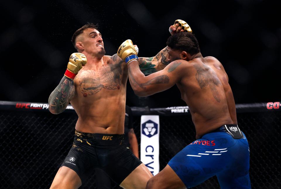 Tom Aspinall (left) drops Curtis Blaydes before sealing the knockout (REUTERS)