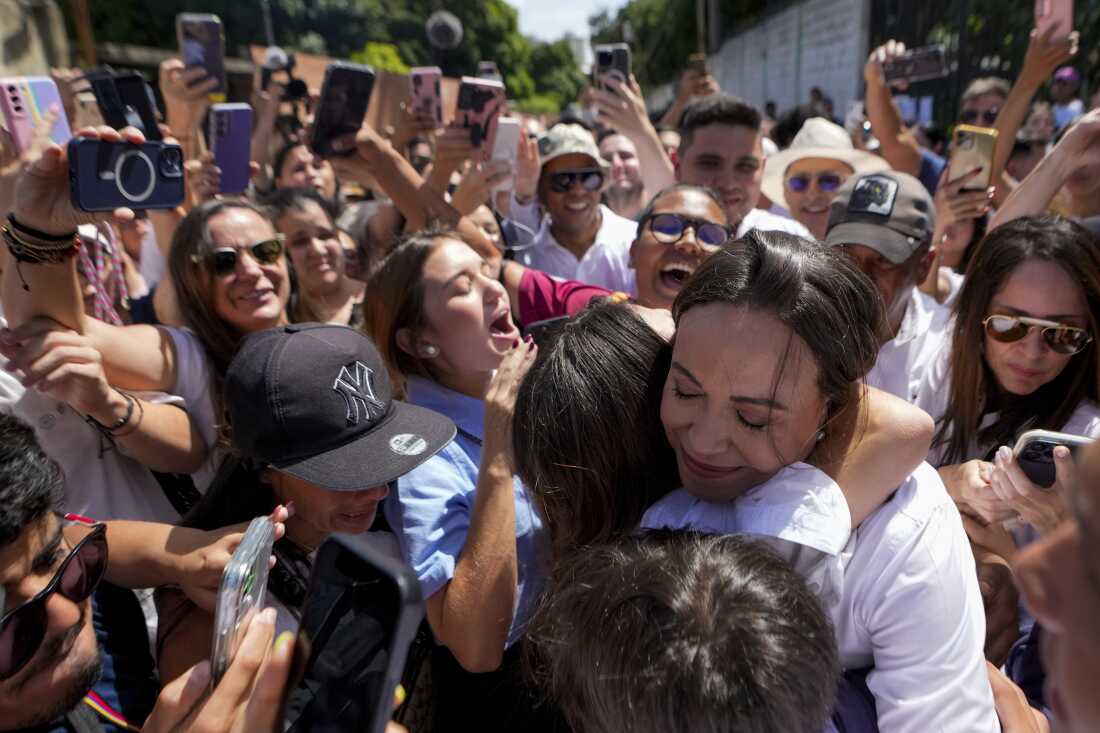 Opposition leader Maria Corina Machado hugs supporters after voting in the presidential election in Caracas, Venezuela, Sunday, July 28, 2024.