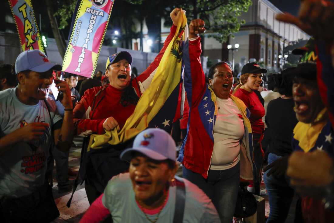 Supporters of President Nicolas Maduro celebrate after electoral authorities declared him the winner of the presidential election in Caracas, Venezuela, Monday, July 29, 2024. 