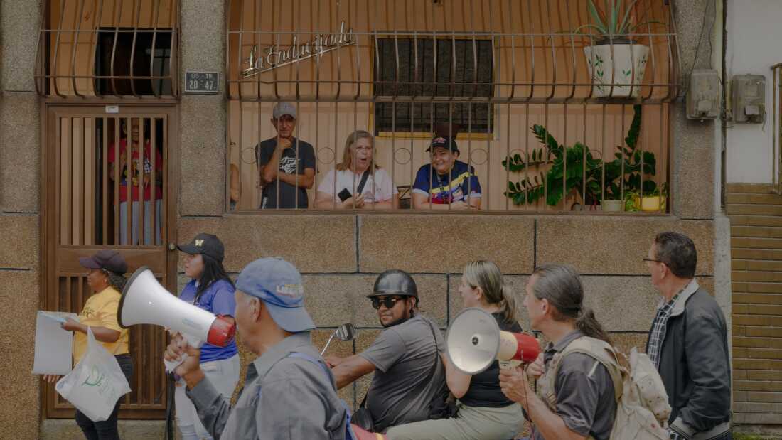 Residents and community organizers take the street in the La Vega neighborhood of Caracas, Venezuela, on Wednesday morning to show support for opposition candidate Edmundo Gónzalez, going door to door to explain the ballot.