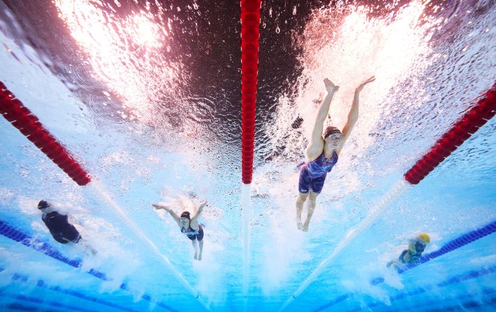 The crowd cheers for a lifeguard after he went into the pool to recover the swim cap of US swimmer Emma Weber on July 28. Lifeguards like this are common at swimming competitions, but it still provided a moment of levity in between races. <a href=