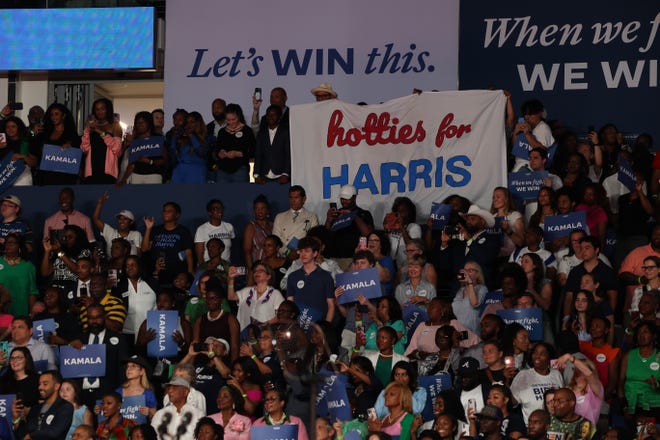 Tuesday, July 30, 2024; Atlanta, Ga; Fans hold a "Hotties for Harris" banner as Megan Thee Stallion performs during a presidential campaign rally for Vice President Kamala Harris on Tuesday, July 30, 2024 at the Georgia State Convocation Center in Atlanta, Ga.