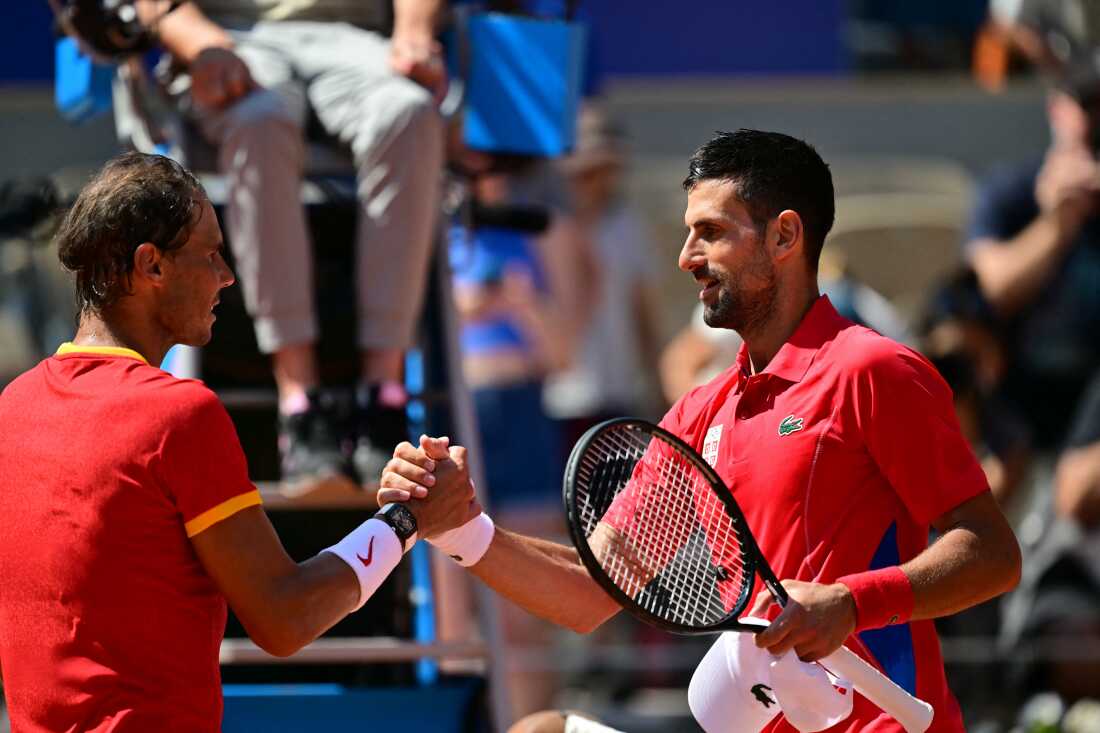 Serbia's Novak Djokovic, right, shakes hands with Spain's Rafael Nadal after the two faced off in the Paris Olympics — their 60th matchup overall. Nadal has been battling injuries for years, but he rallied for a number of dramatic points in front of an appreciative crowd at Court Philippe-Chatrier at the Roland-Garros Stadium at the Paris 2024 Olympic Games, in Paris on July 29, 2024. (Photo by Martin BERNETTI / AFP) (Photo by MARTIN BERNETTI/AFP via Getty Images)