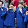 Team USA's men's swimming team stands on the podium after winning gold in the men's 400-meter freestyle relay final at the Paris Olympics on Saturday.