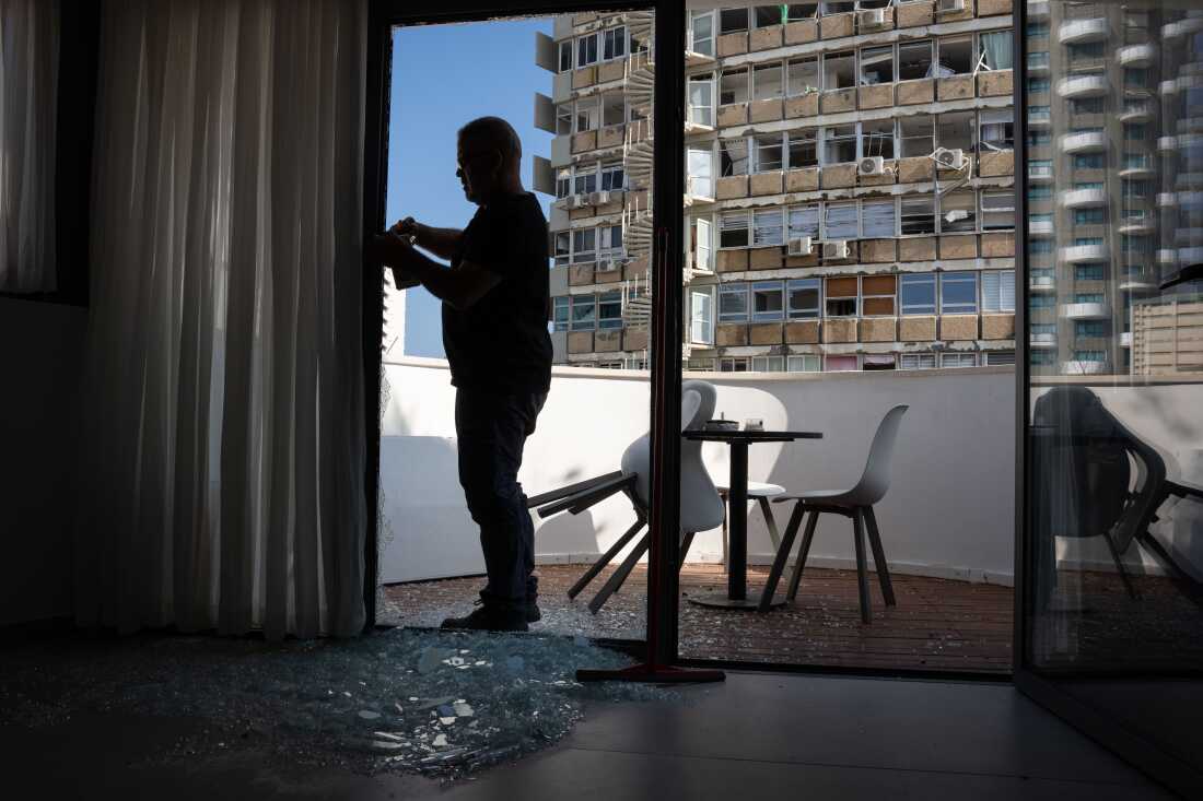 A workmen measures a door in a building damaged by an explosion in Tel Aviv, Israel on July 19. One person was killed and eight people injured following a loud explosion near a branch of the US embassy in Tel Aviv early on Friday.