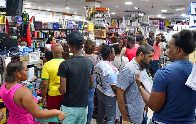 People shop for supplies in a supermarket ahead of the arrival of Hurricane Beryl in Bridgetown, Barbados June 30, 2024.