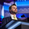 J.D. Vance, Donald Trump's vice presidential running mate, stands at a podium during a walkthrough for the 2024 Republican National Convention at the Fiserv Forum in Milkwaukee, WI.