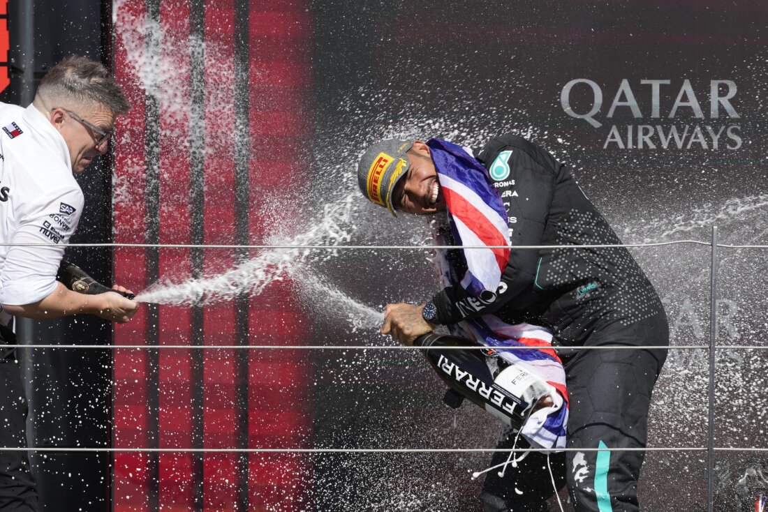 Mercedes driver Lewis Hamilton, right, celebrates on the podium after winning the British Formula One Grand Prix race at the Silverstone racetrack in Silverstone, England, on Sunday.