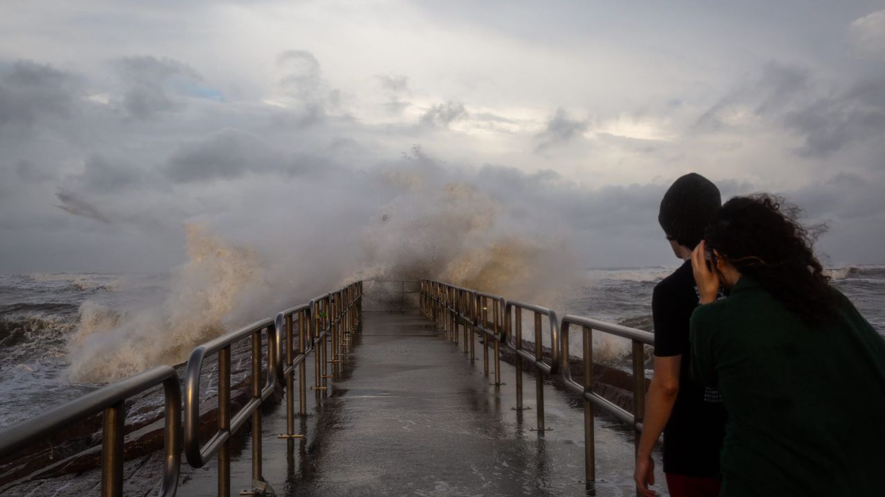 People watch large swells created by Hurricane Beryl crash over the Packery Channel Jetty on Sunday evening, July 7, in Corpus Christi, Texas.