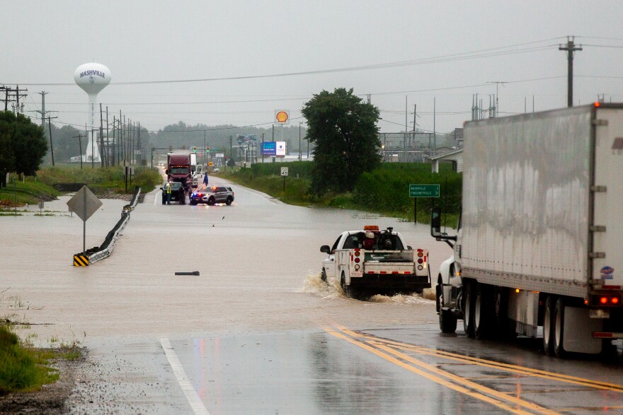 Cars are stopped as floodwaters pour onto Illinois Route 127 on Tuesday, July 16, 2024, just oustside Nashville, Illinois.