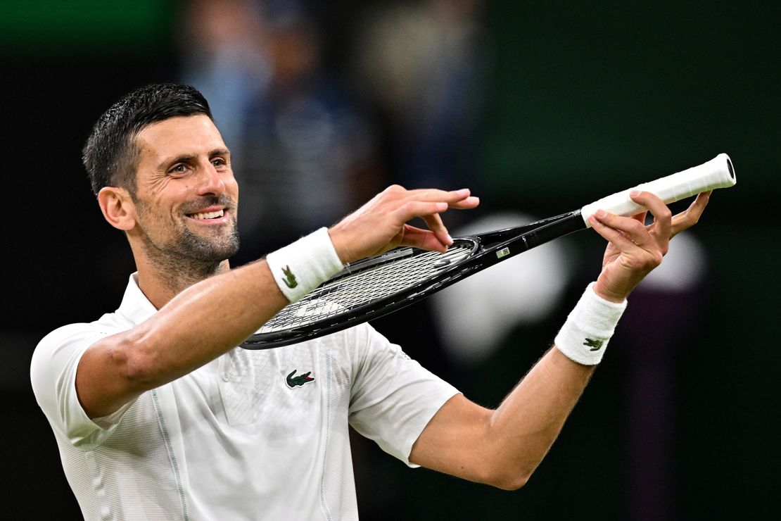 Djokovic pretends to play the violin for his daughter as he celebrates winning against Denmark's Holger Rune.