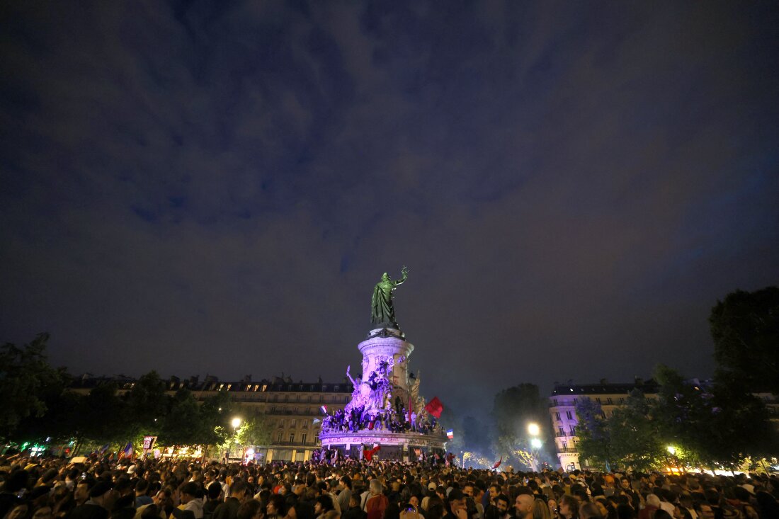 Participants gather during an election night rally following the first results of the second round of France's legislative election at Place de la Republique in Paris on Sunday.