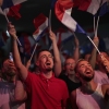 Supporters of French far-right leader Marine Le Pen react after vote projections in select constituencies, Sunday, in Henin-Beaumont, northern France. French voters propelled the far-right National Rally to a strong lead in first-round legislative elections Sunday and plunged the country into political uncertainty.