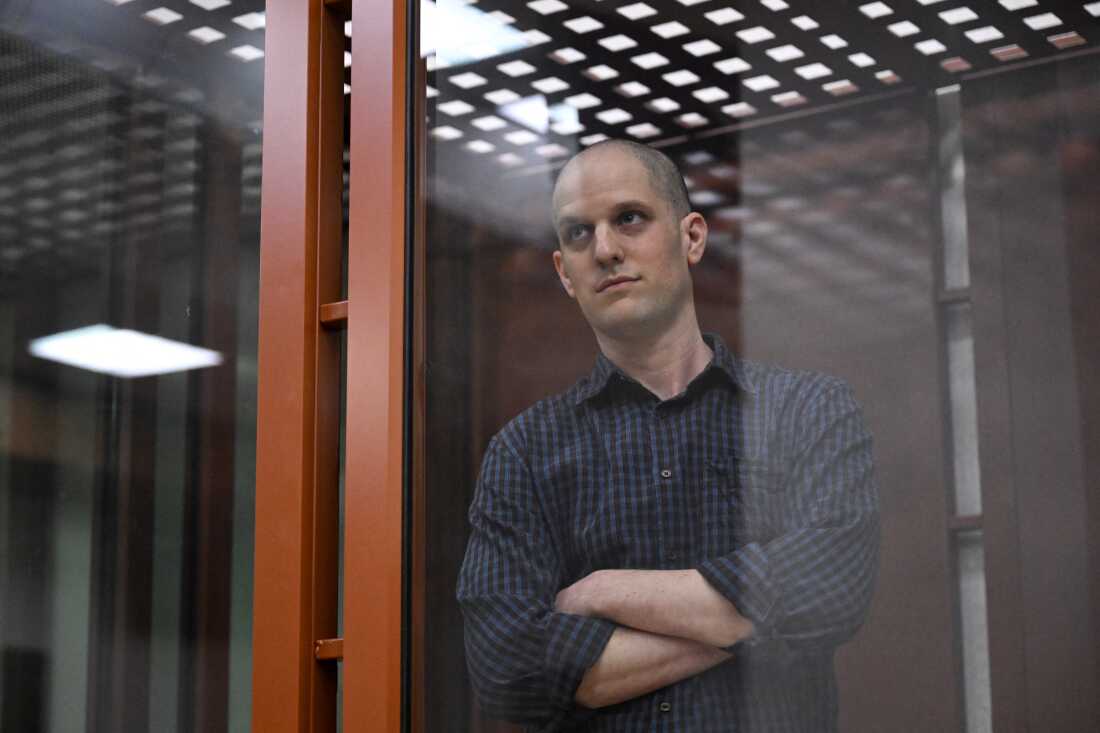 US journalist Evan Gershkovich, accused of espionage, looks out from inside a glass defendants' cage prior to a hearing in Yekaterinburg's Sverdlovsk Regional Court on June 26, 2024.