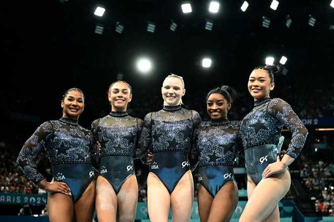 (From L) US&apos; Jordan Chiles, US&apos; Hezly Rivera, US&apos; Jade Carey, US&apos; Simone Biles and US&apos; Sunisa Lee pose during the artistic gymnastics women&apos;s qualification during the Paris 2024 Olympic Games at the Bercy Arena in Paris, on July 28, 2024. (Photo by Loic VENANCE / AFP) (Photo by LOIC VENANCE/AFP via Getty Images)