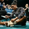 The U.S. gymnast Simone Biles appeared to hurt her lower left leg during a warmup on Sunday, but she finished the remaining events after wrapping her ankle with thick athletic tape.