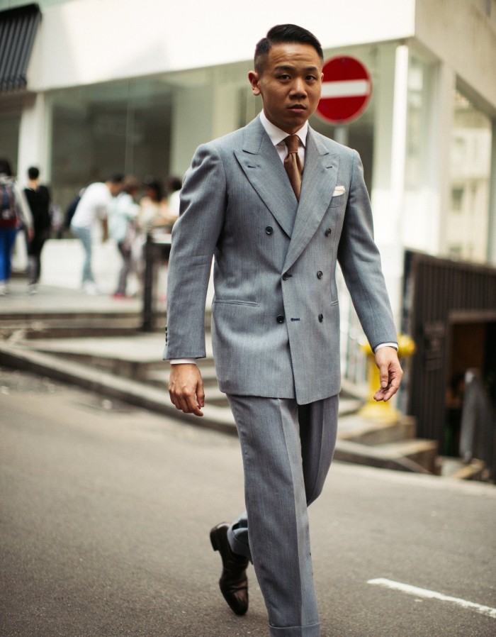 Jerry Tong of Hong Kong tailor Prologue walking down the street wearing a grey suit