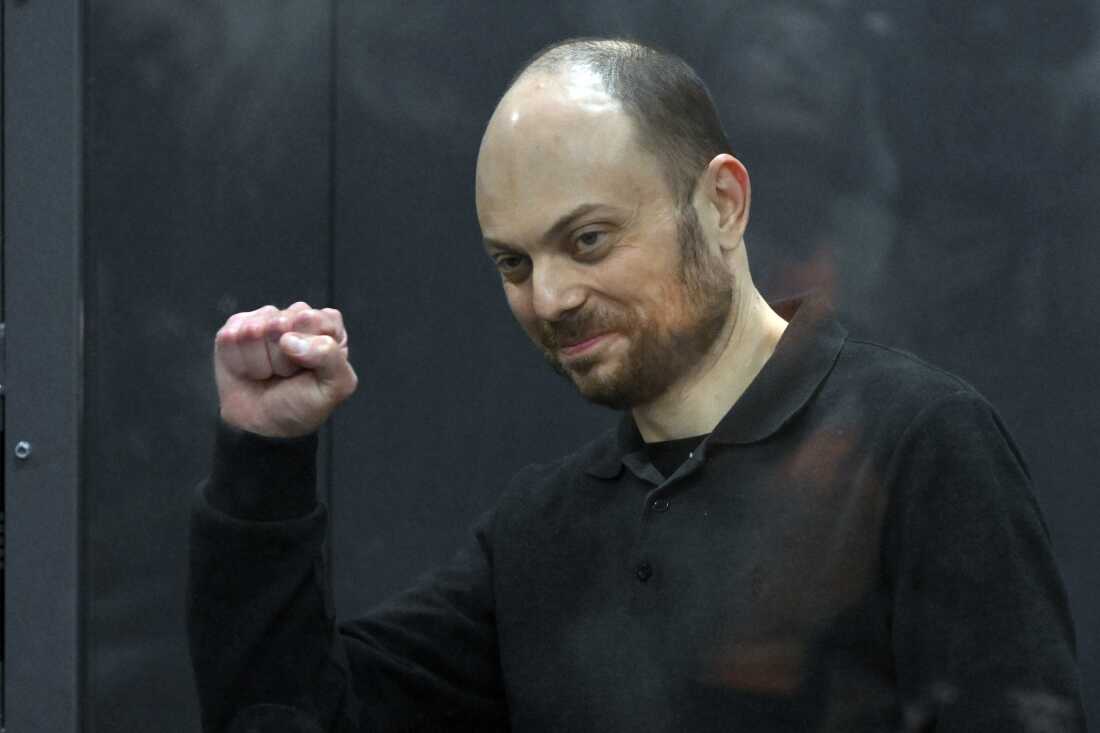 Russian opposition activist Vladimir Kara-Murza gestures while standing in a glass cage in a courtroom during announcement of the verdict on appeal at the Moscow City Court in Moscow on July 31, 2023.