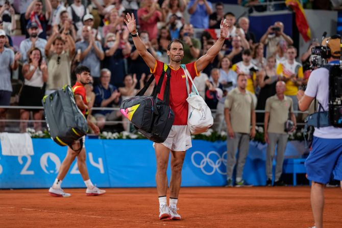 Spain's Rafael Nadal waves goodbye after he and doubles partner Carlos Alcaraz <a href=