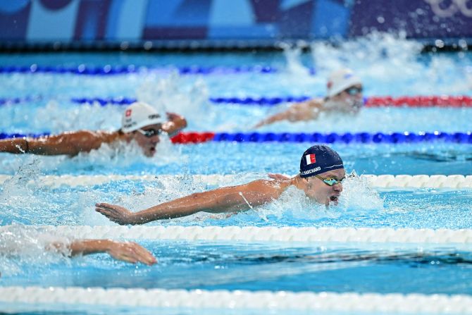 France's Léon Marchand leads the 200-meter butterfly final on July 31. <a href=