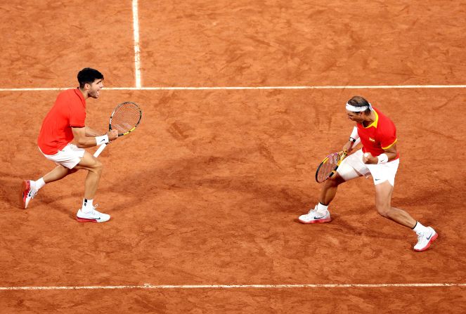 Spanish tennis players Carlos Alcaraz and Rafael Nadal celebrate during a doubles match on July 27. <a href=