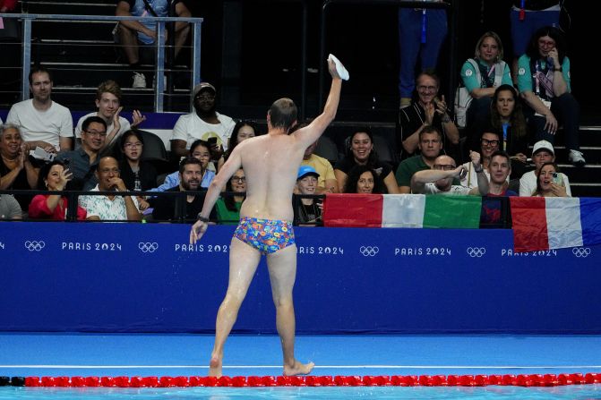 The crowd cheers for a lifeguard after he went into the pool to recover the swim cap of US swimmer Emma Weber on July 28. Lifeguards like this are common at swimming competitions, but it still provided a moment of levity in between races. <a href=